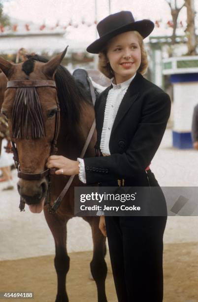 Portrait of Beatrice Lodge, daughter of United States Ambassador to Spain John Lodge, wearing ruffled shirt and flat Cordoban hat. Seville, Spain...