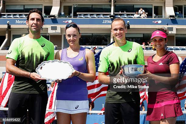 Sania Mirza of India and Bruno Soares of Brazil celebrate with the trophy after defeating Santiago Gonzalez of Mexico and Abigail Spears of the...