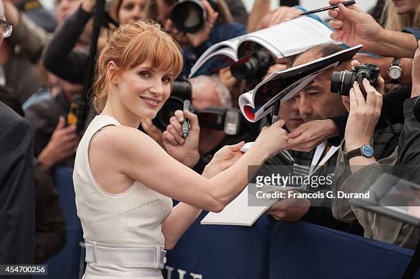 Jessica Chastain signs autographs as she arrives to unveil her dedicated beach locker room on the Promenade des Planches on September 5, 2014 in...