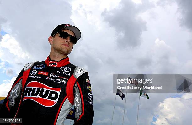 James Buescher, driver of the Ruud Toyota, looks on from the grid during qualifying for the NASCAR Nationwide Series Virginia529 College Savings 250...