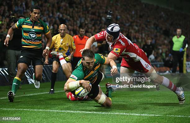 Jon Fisher of Northampton dives over to score their sixth try during the Aviva Premiership match between Northampton Saints and Gloucester at...