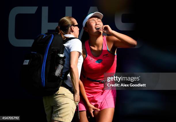 Shuai Peng of China reacts after getting injured during her women's singles semifinal match against Caroline Wozniacki of Denmark on Day Twelve of...