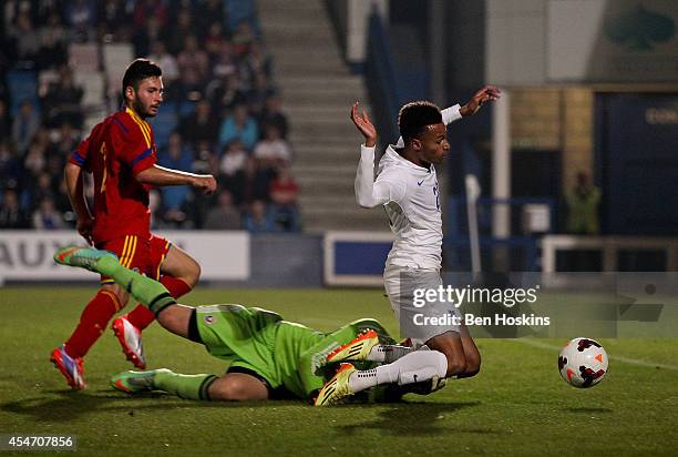 Josh Murphy of England is bought down by Razvan Began of Romania in the penalty area during the U20 International friendly match between England and...