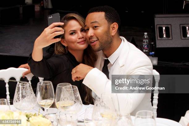 Chrissy Teigen and John Legend attend the White Party Dinner Hosted by Andrea and Veronica Bocelli Celebrating Celebrity Fight Night In Italy...