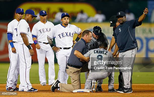 Endy Chavez of the Seattle Mariners leaves the game after cutting his head sliding into second base against the Texas Rangers in the top of the fifth...