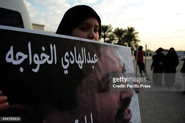 Bahraini girl carries a poster of the famous Jurist Abdul Hadi al-Khawaja, who entered into an open ended hunger strike, she is demanding the release...