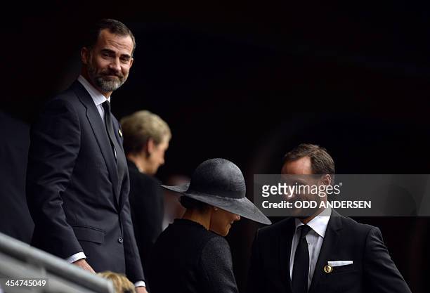 Spain's Prince Felipe speaks with Norway's Crown Prince Haakon and Sweden's Crown Princess Victoria as they arrive for the memorial service of South...