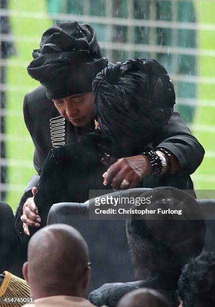 Winnie Madikizela-Mandela and Graca Machel embrace as they arrive for the official memorial service for former South African President Nelson Mandela...