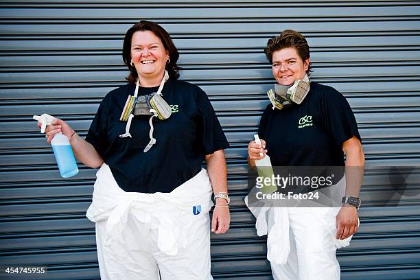 Sisters Eileen de Jager and Roelien Schutte, who make a living from cleaning up crime scenes, pose together in their cleaning kit on November 30,...