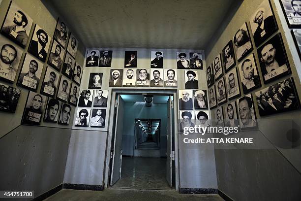 Picture taken on September 2, 2014 in the Iranian capital Tehran shows portraits of detainees displayed on a wall of "Qasr prison", a former prison...