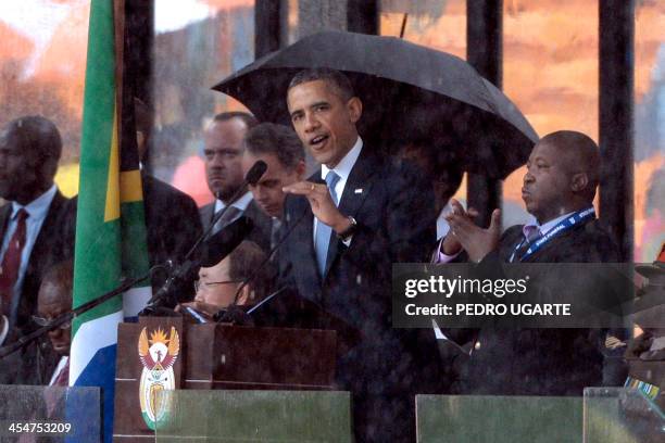 Sign language interpreter gestures as US President Barack Obama delivers a speech during the memorial service for late South African President Nelson...