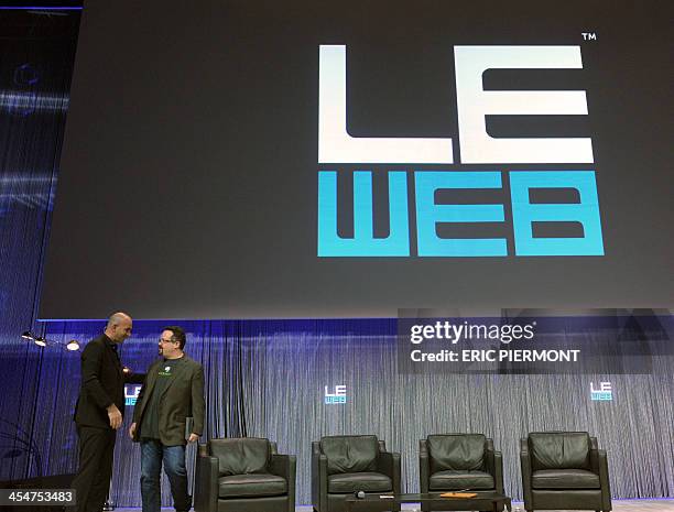 Evernote CEO Phil Libin is greeted by LeWeb co-founder Loic Le Meur on stage during a session of LeWeb 2013 event in Saint-Denis, near Paris, on...