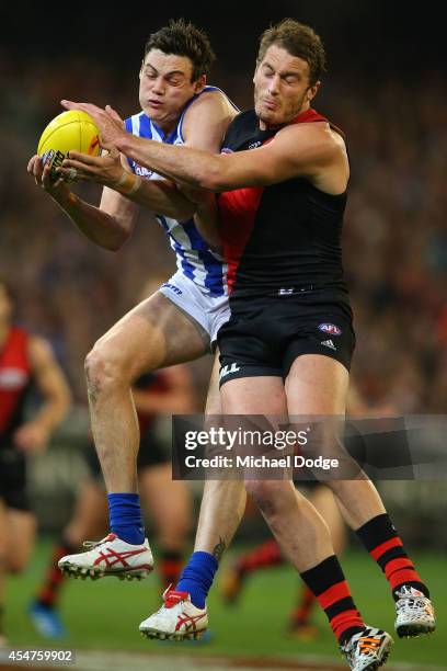 Nathan Grima of the Kangaroos marks the ball against Tom Bellchambers of the Bombers during the Second Elimination AFL Final match between the North...