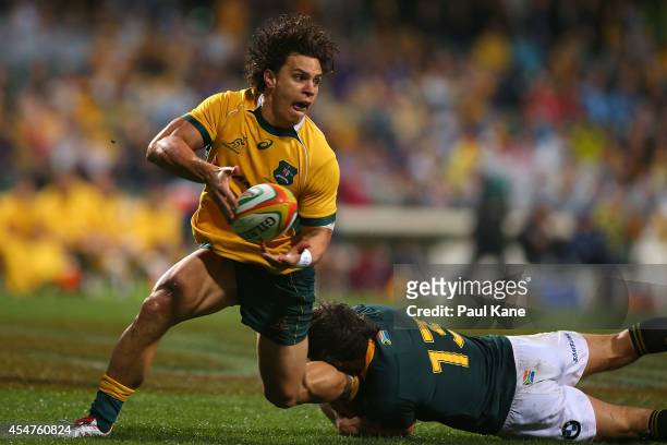 Matt Toomua of the Wallabies looks to pass the ball while being tackled by Jan Serfontein of the Springboks during The Rugby Championship match...
