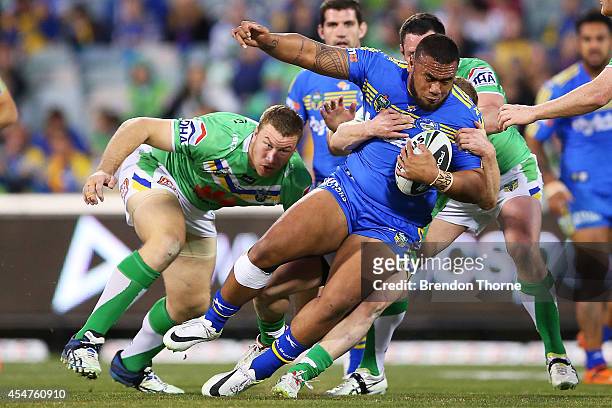 Junior Paulo of the Eels is tackled by the Raiders defence during the round 26 NRL match between the Canberra Raiders and the Parramatta Eels at GIO...