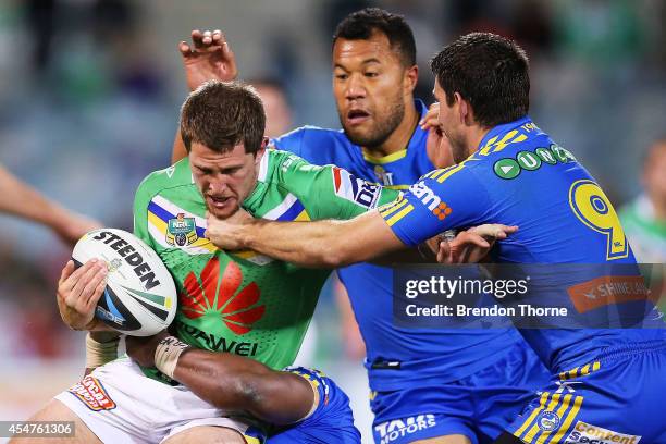 Jarrad Kennedy of the Raiders is tackled by the Eels defence during the round 26 NRL match between the Canberra Raiders and the Parramatta Eels at...