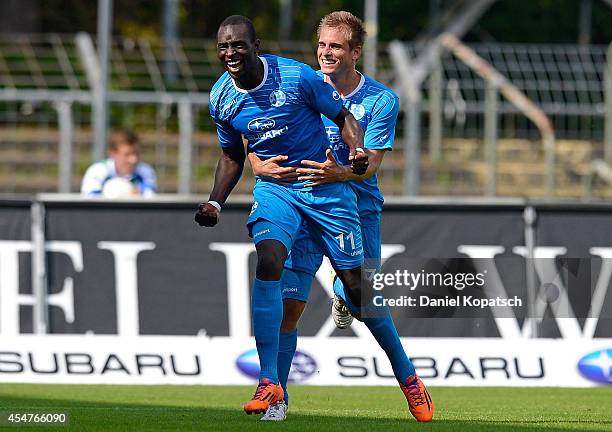 Lhadji Badiane of Stuttgart celebrates his team's second goal with team mate Fabian Gerster during the third Bundesliga match between Stuttgarter...