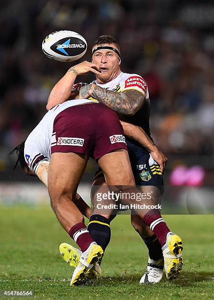 Tariq Sims of the Cowboys is tackled by Steve Matai of the Sea Eagles during the round 26 NRL match between the North Queensland Cowboys and the...
