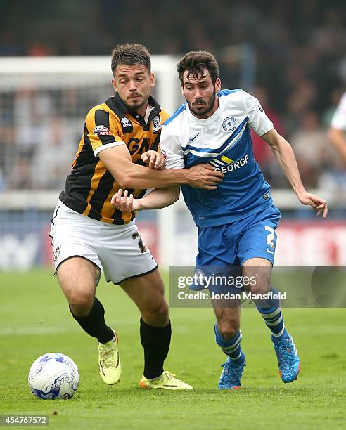 Michael Smith of Peterborough tackles with Frederic Veseli of Port Vale during the Sky Bet League One match between Peterborough United and Port Vale...