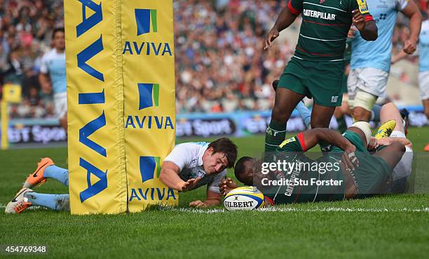 Adam Powell of the Falcons fails to stop Tigers winger Vereniki Goneva from scoring his second try during the Aviva Premiership match between...