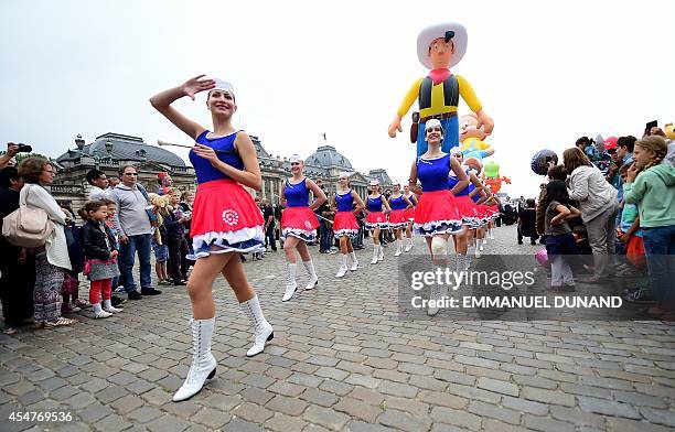 An inflatable of Belgian comics series character Lucky Luke is paraded behind majorettes performing during the Balloon's Day Parade as part of the...