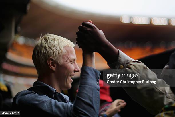 Members of the public sing and dance during the Nelson Mandela memorial service at the FNB Stadium, on December 10, 2013 in Johannesburg, South...