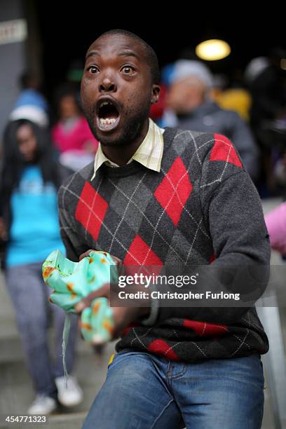 Man sings and dances during the Nelson Mandela memorial service at the FNB Stadium, on December 10, 2013 in Johannesburg, South Africa. Over 60 heads...