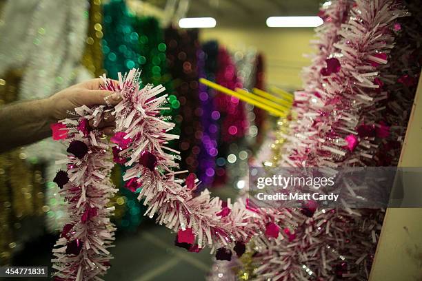 Freshly made tinsel samples is inspected in the factory part of the Festive Productions Ltd premises on December 10, 2013 in Cwmbran, Wales. Although...