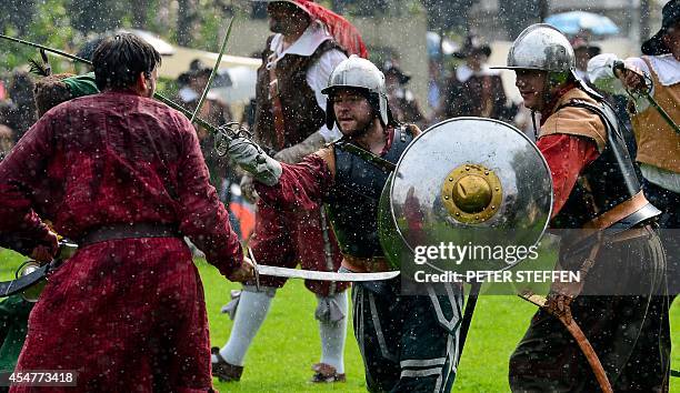 Men in historical costumes re-enact a battle at the Sehusafest medieval festival in Seesen, central Germany, on September 6, 2014. Organisers expect...