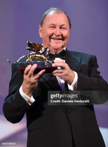 Director Roy Andersson poses onstage with the Golden Lion for Best Film he received for his movie 'A Pigeon Sat on a Branch Reflecting on Existence'...