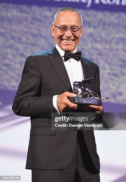 Director Andrey Konchalovskiy poses onstage with the Silver Lion for Best Director he received for his movie 'The Postman's White Nights ' during the...