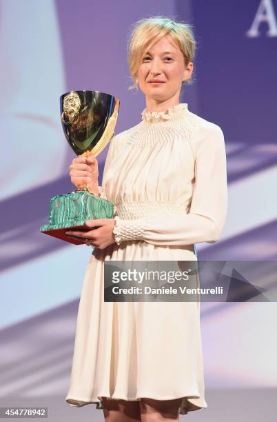 Actress Alba Rohrwacher poses onstage with the Best Actress award she received for her role in the movie 'Hungry Hearts' during the closing ceremony...