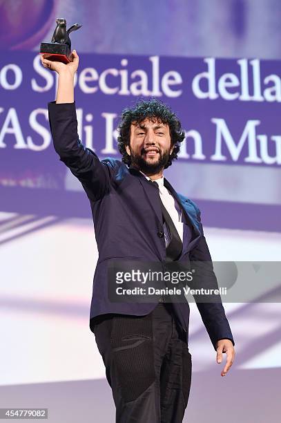 Director Kaan Mujdeci poses onstage with the Special Jury Prize he received for his movie 'Sivas' during the closing ceremony of the 71st Venice Film...