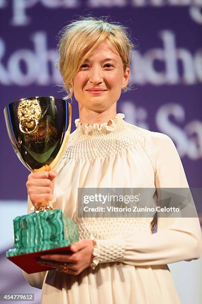 Actress Alba Rohrwacher poses on stage with her Best Actress award for Hungry Hearts on stage during the Closing Ceremony of the 71st Venice Film...