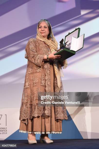 Director Rakhshan Banietemad poses onstage with the Best Screenplay award she received for her movie 'Ghesseha ' during the closing ceremony of the...