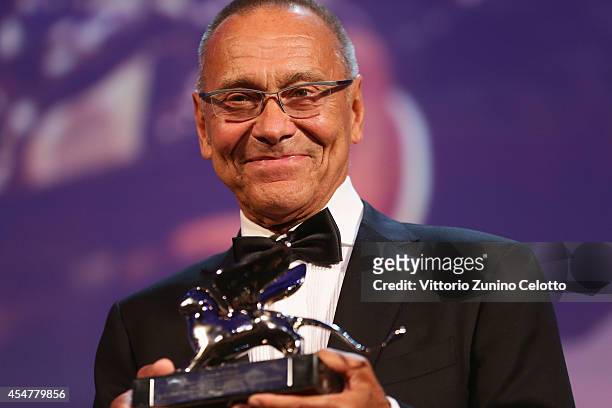 Director Andrei Konchalovsky poses with the Silver Lion Award for "The Postman's White Knights" on stage during the Closing Ceremony of the 71st...