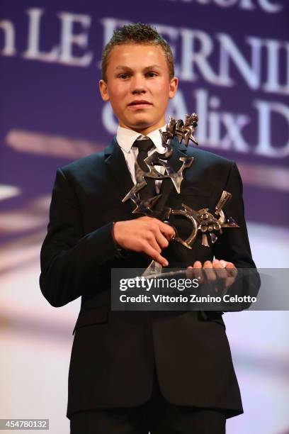 Actor Romain Paul poses with his award for Best Young Actor or Actress on stage during the Closing Ceremony of the 71st Venice Film Festival on...