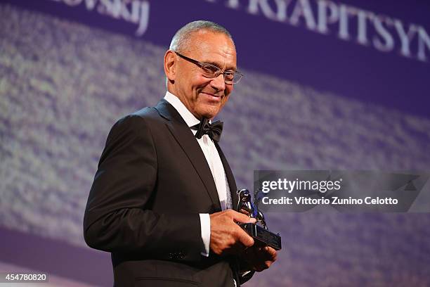 Director Andrei Konchalovsky poses with the Silver Lion Award for "The Postman's White Knights" on stage during the Closing Ceremony of the 71st...