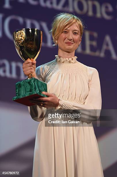 Actress Alba Rohrwacher poses on stage with her Best Actress award for Hungry Hearts on stage during the Closing Ceremony of the 71st Venice Film...