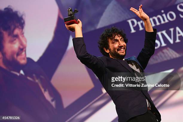 Director Kaan Mujdeci poses onstage with the Special Jury Prize he received for his movie 'Sivas' on stage during the Closing Ceremony of the 71st...