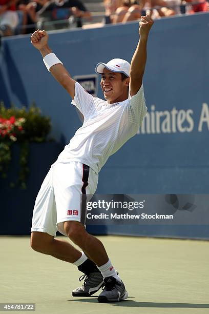 Kei Nishikori of Japan celebrates after defeating Novak Djokovic of Serbia in their men's singles semifinal match on Day Thirteen of the 2014 US Open...
