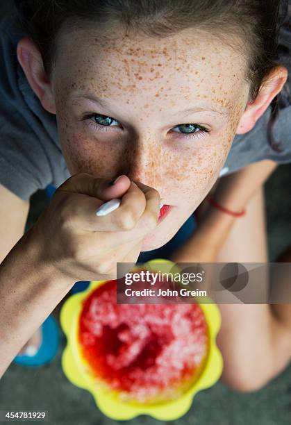 Girl enjoys shaved ice treat.