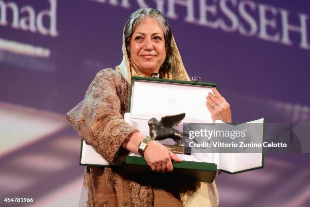 Director Rakhshan Banietemad poses onstage with the Best Screenplay award she received for her movie 'Ghesseha ' on stage during the Closing Ceremony...