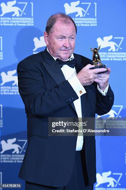 Director Roy Andersson poses with the Golden Lion for Best Film he received for his movie 'A Pigeon Sat on a Branch Reflecting on Existence' during...