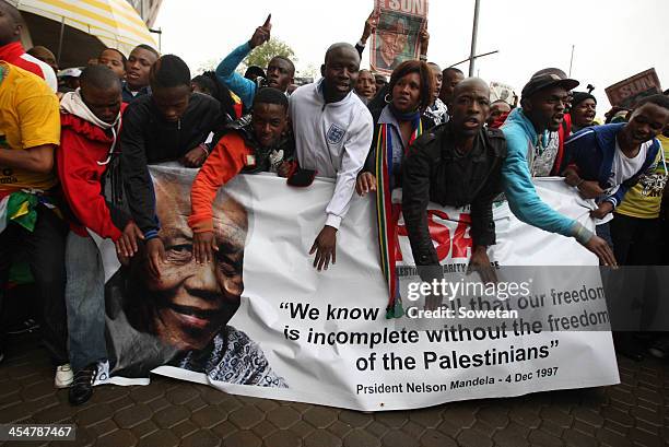 Thousands of people gathered to pay homage to the late former president Nelson Mandela at a memorial service in Johannesburg held at FNB stadium, on...