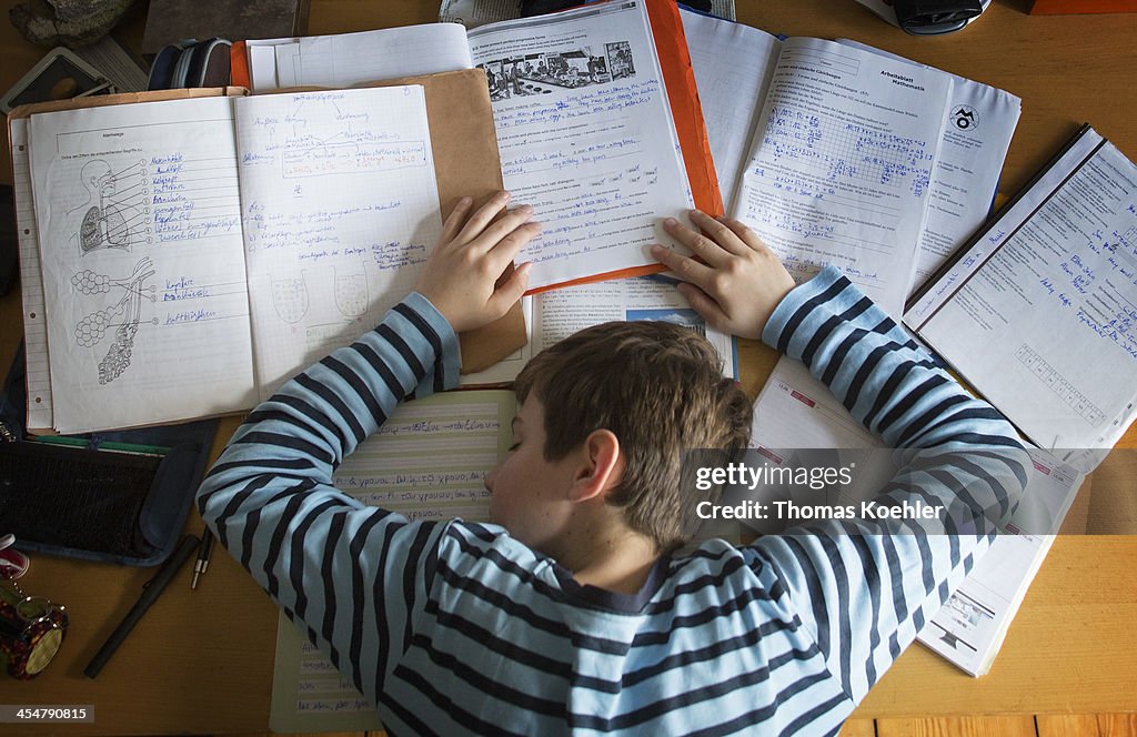 Exhausted Boy At His Desk