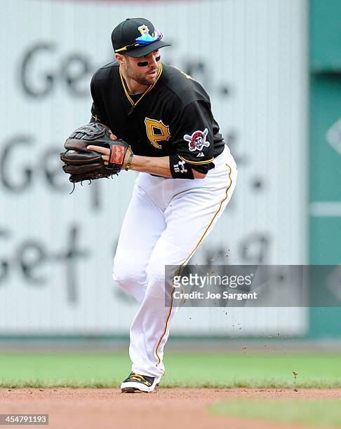 Neil Walker of the Pittsburgh Pirates fields a ground ball during Game Four of the National League Division Series against the St. Louis Cardinals on...