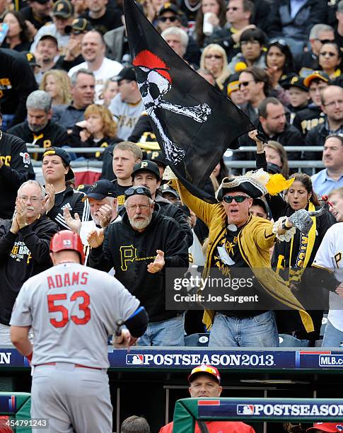 Pittsburgh Pirates fans taunt Matt Adams of the St. Louis Cardinals as he enters the dugout following a strikeout during Game Four of the National...