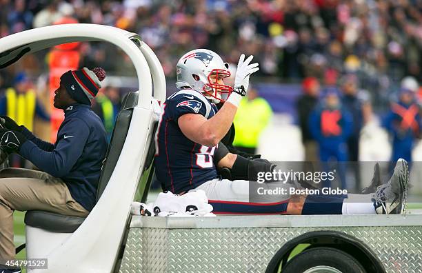 Patriots tight end Rob Gronkowski waves to the Gillette Stadium faithful after being carted off with a torn ACL and MCL after getting hit low on the...