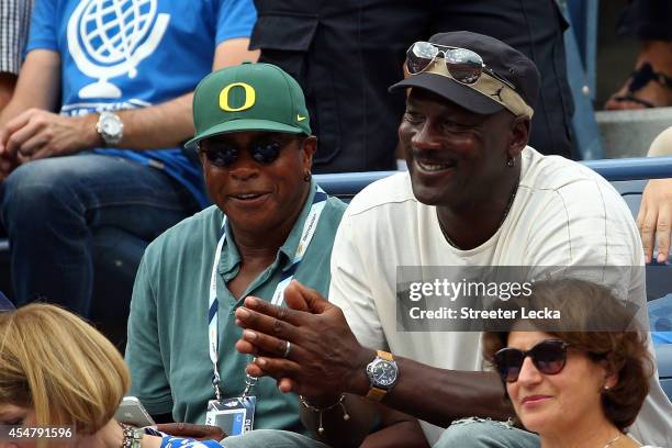 Personality Ahmad Rashad and Basketball Hall of Famer Michael Jordan attend the men's singles semifinal match between Roger Federer of Switzerland...